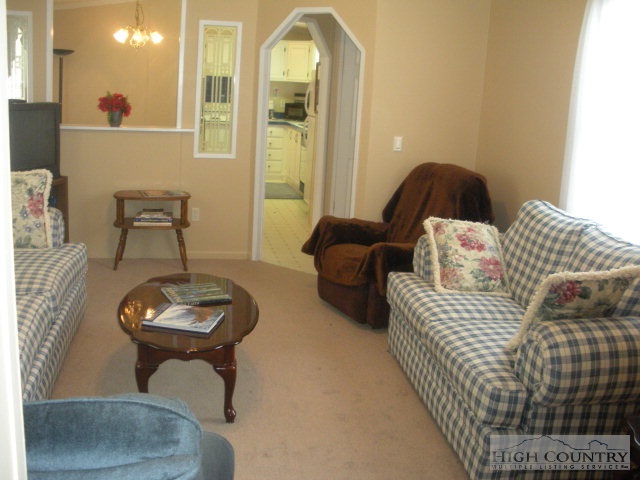 73 Smith Acres Road Ennice, NC 28623 - Photo 18 of 22 a living room with furniture and a painting