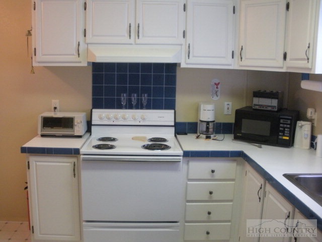 73 Smith Acres Road Ennice, NC 28623 - Photo 21 of 22 a kitchen with a stove and a cabinets