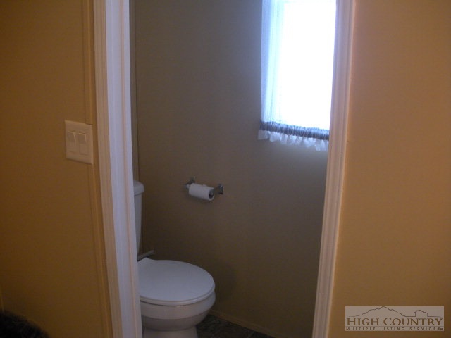 73 Smith Acres Road Ennice, NC 28623 - Photo 9 of 22 a bathroom with a granite countertop toilet and a sink