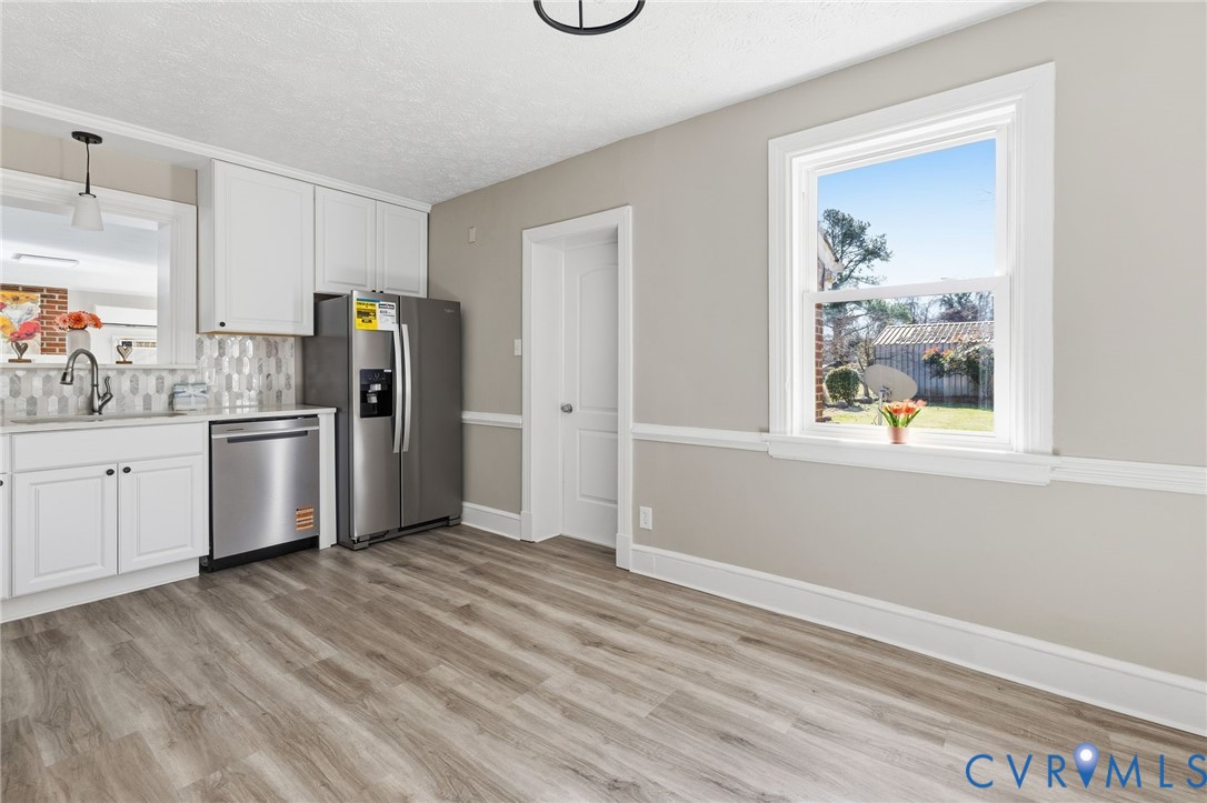 5607 Jahnke Road Richmond, VA 23225 - Photo 11 of 28 Kitchen featuring white cabinetry, appliances with