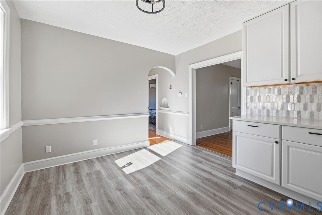 5607 Jahnke Road Richmond, VA 23225 - Photo 15 of 28 Unfurnished dining area featuring arched walkways,