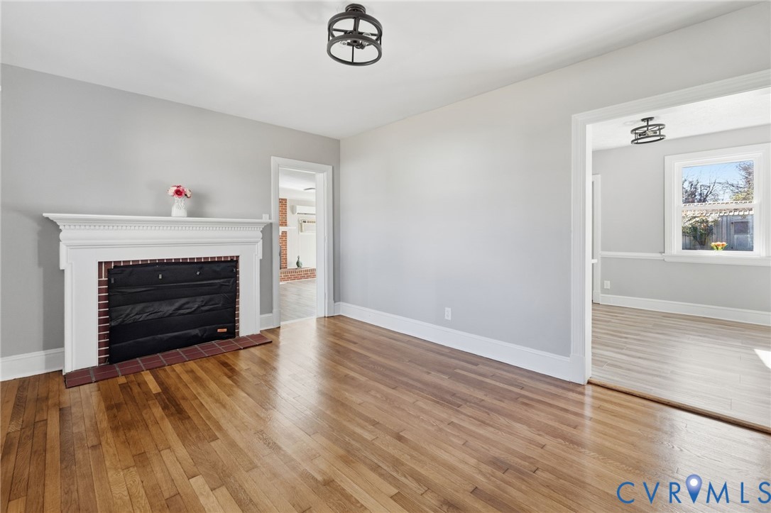 5607 Jahnke Road Richmond, VA 23225 - Photo 4 of 28 Unfurnished living room with a fireplace with flus