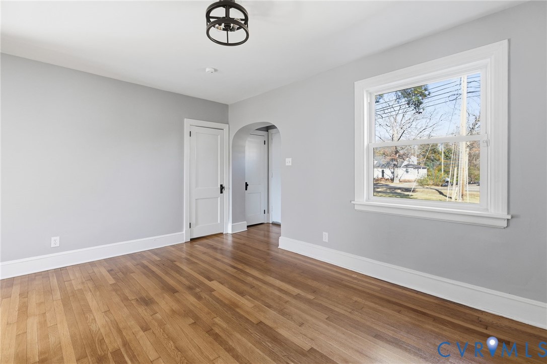 5607 Jahnke Road Richmond, VA 23225 - Photo 6 of 28 Unfurnished room with arched walkways and hardwood