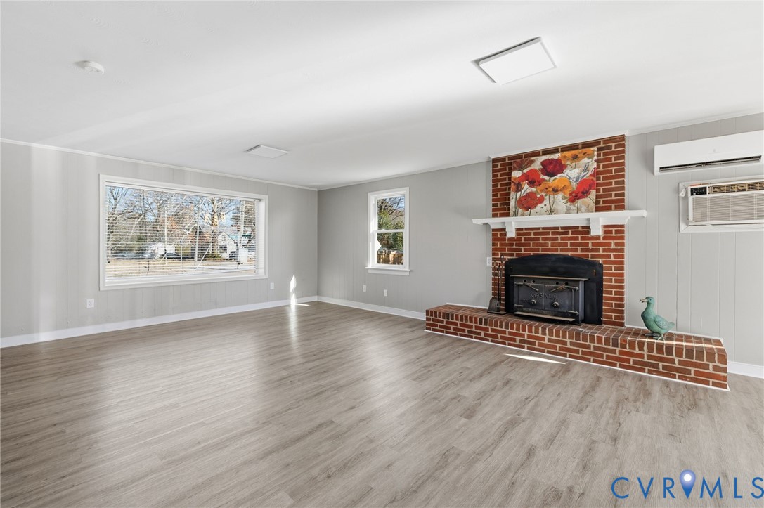 5607 Jahnke Road Richmond, VA 23225 - Photo 7 of 28 Unfurnished living room featuring light wood-style