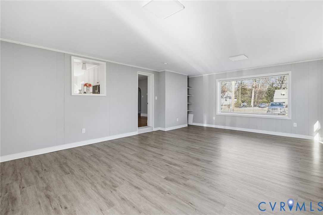 5607 Jahnke Road Richmond, VA 23225 - Photo 9 of 28 Spare room featuring wooden walls and light wood-s