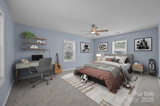 a spacious bedroom with a bed a desk and chair