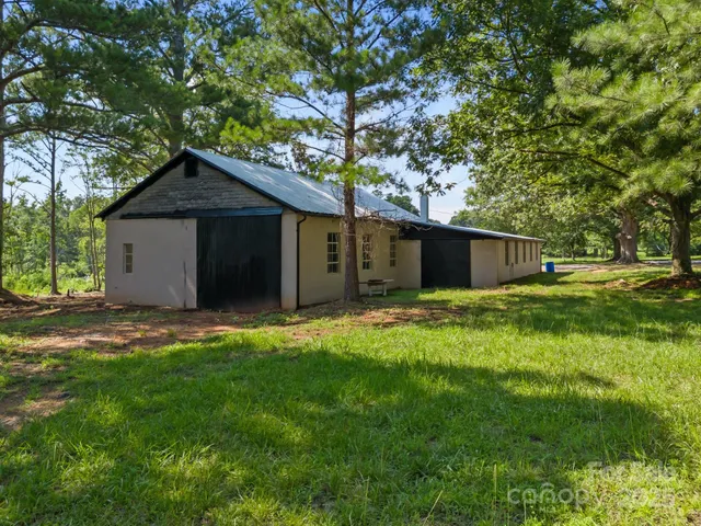 a front view of house with a garden