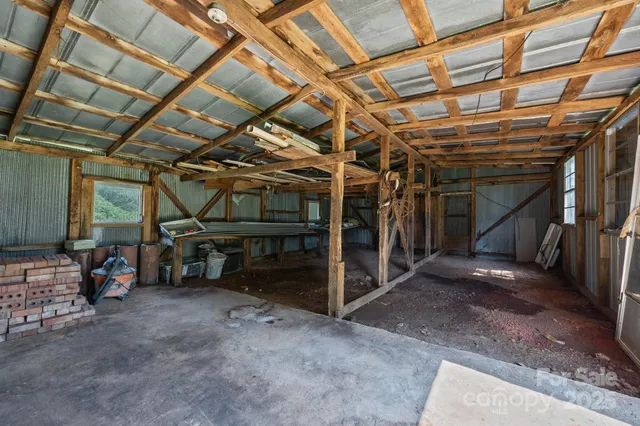 a view of empty room with wooden ceiling