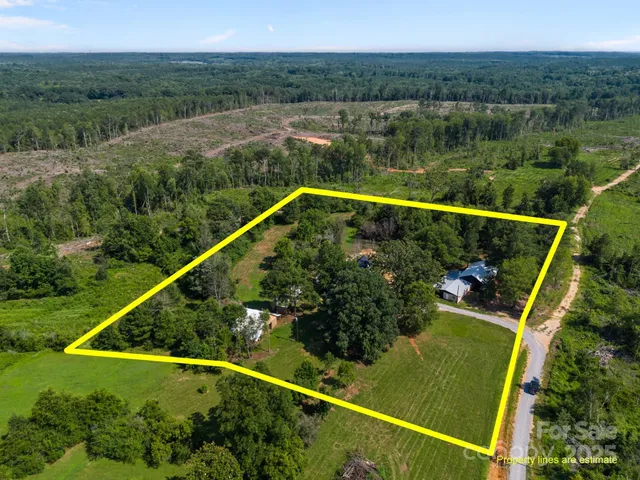 an aerial view of mountains with green space