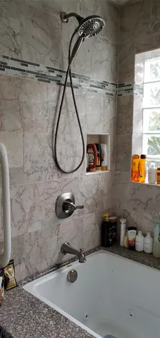 a bathroom with a shower and mirror