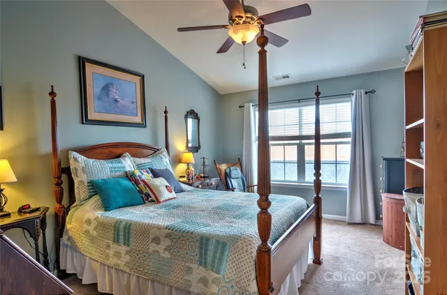 a bed room with a bed and a chandelier