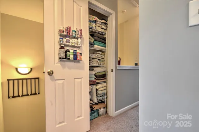 a view of a hallway with wooden shelves