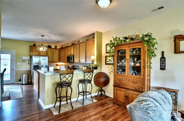 a view of a dining room with furniture and chandelier
