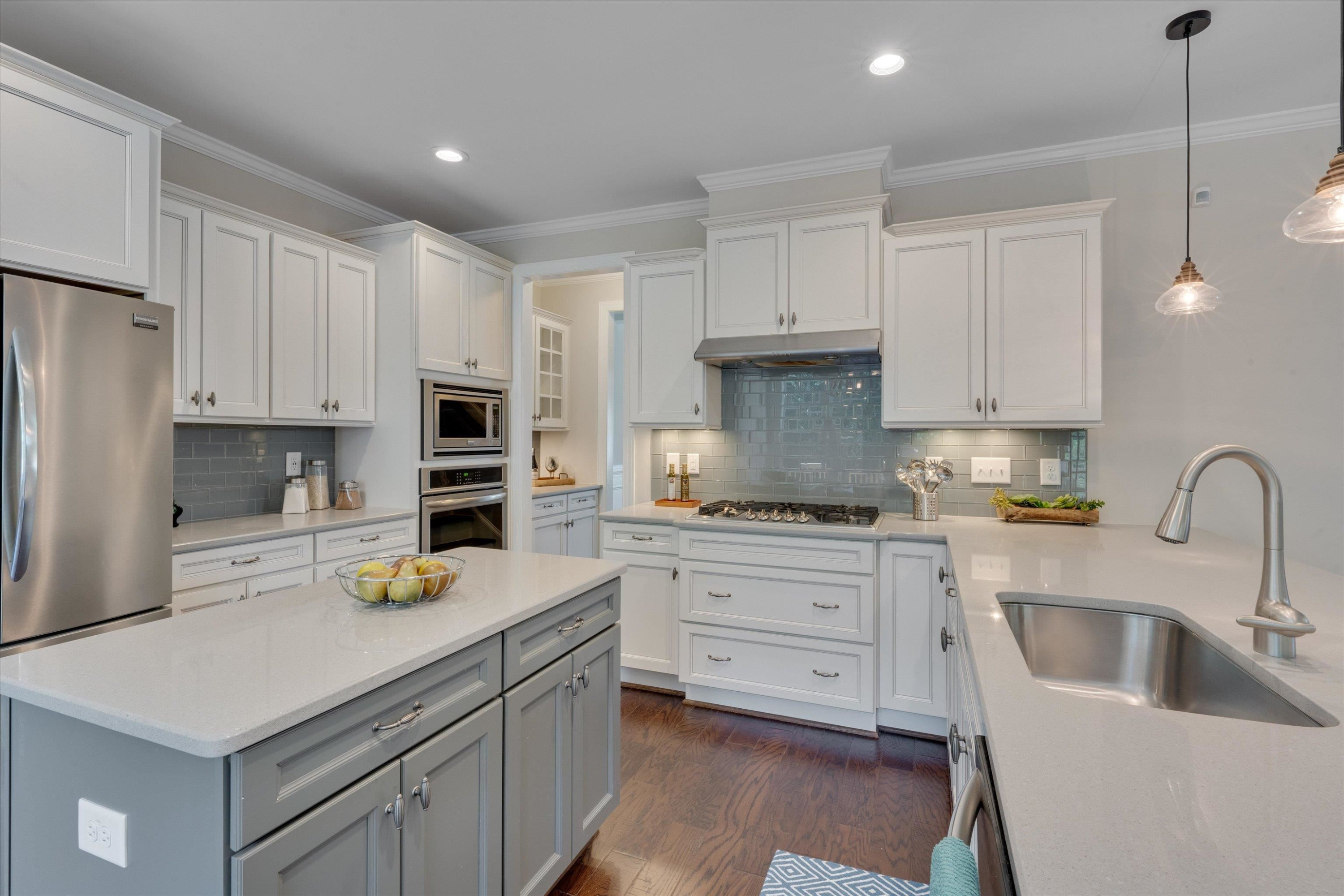 2617 Needle Pine Drive Apex, NC 27539 - Photo 12 of 42 a kitchen with a sink white cabinets and white appliances