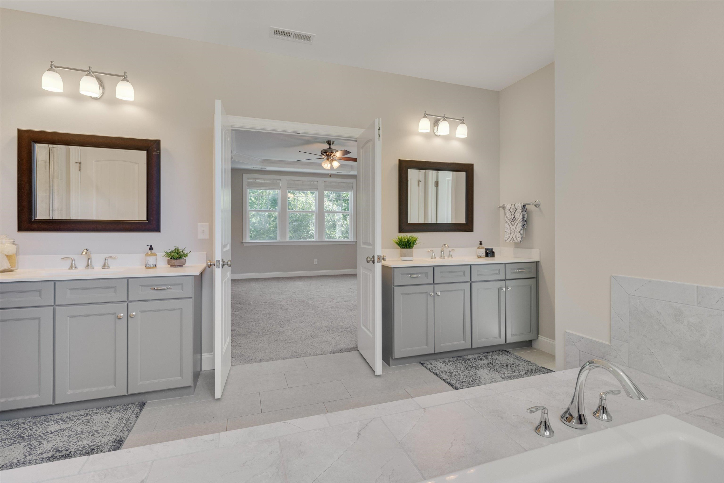 2617 Needle Pine Drive Apex, NC 27539 - Photo 19 of 42 a bathroom with a sink a toilet and mirror