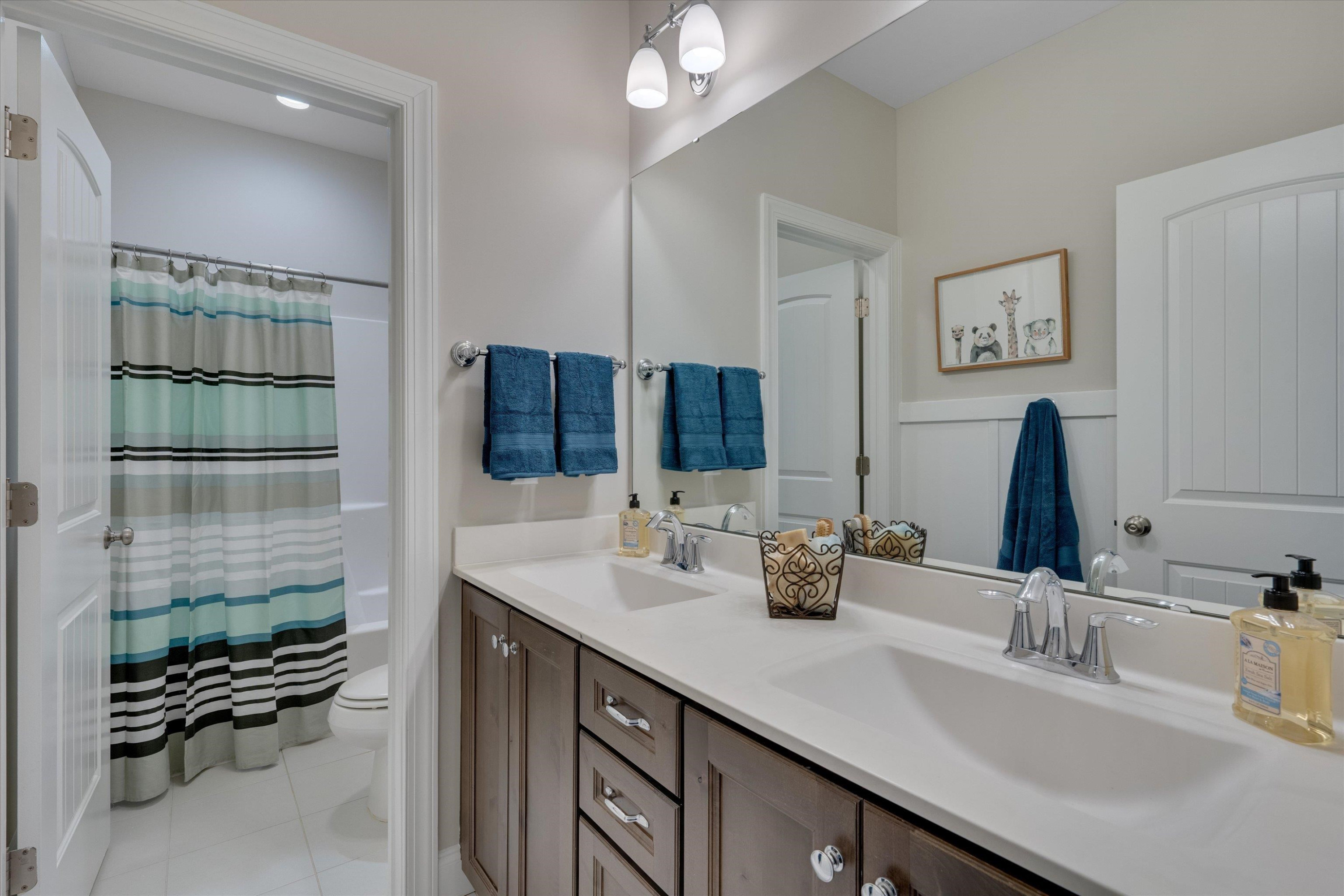 2617 Needle Pine Drive Apex, NC 27539 - Photo 21 of 42 a bathroom with a double vanity sink a mirror and shower