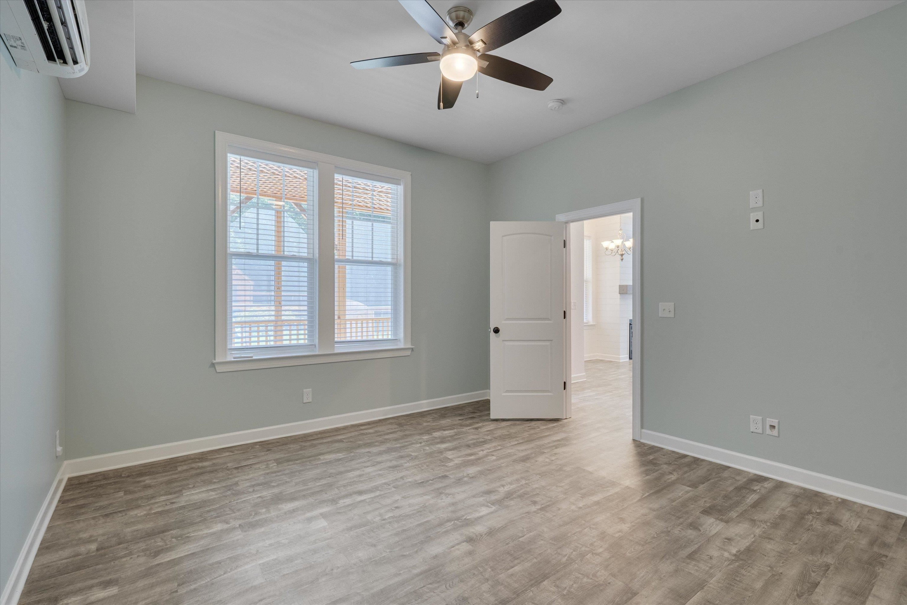 2617 Needle Pine Drive Apex, NC 27539 - Photo 28 of 42 a view of an empty room with window and chandelier fan