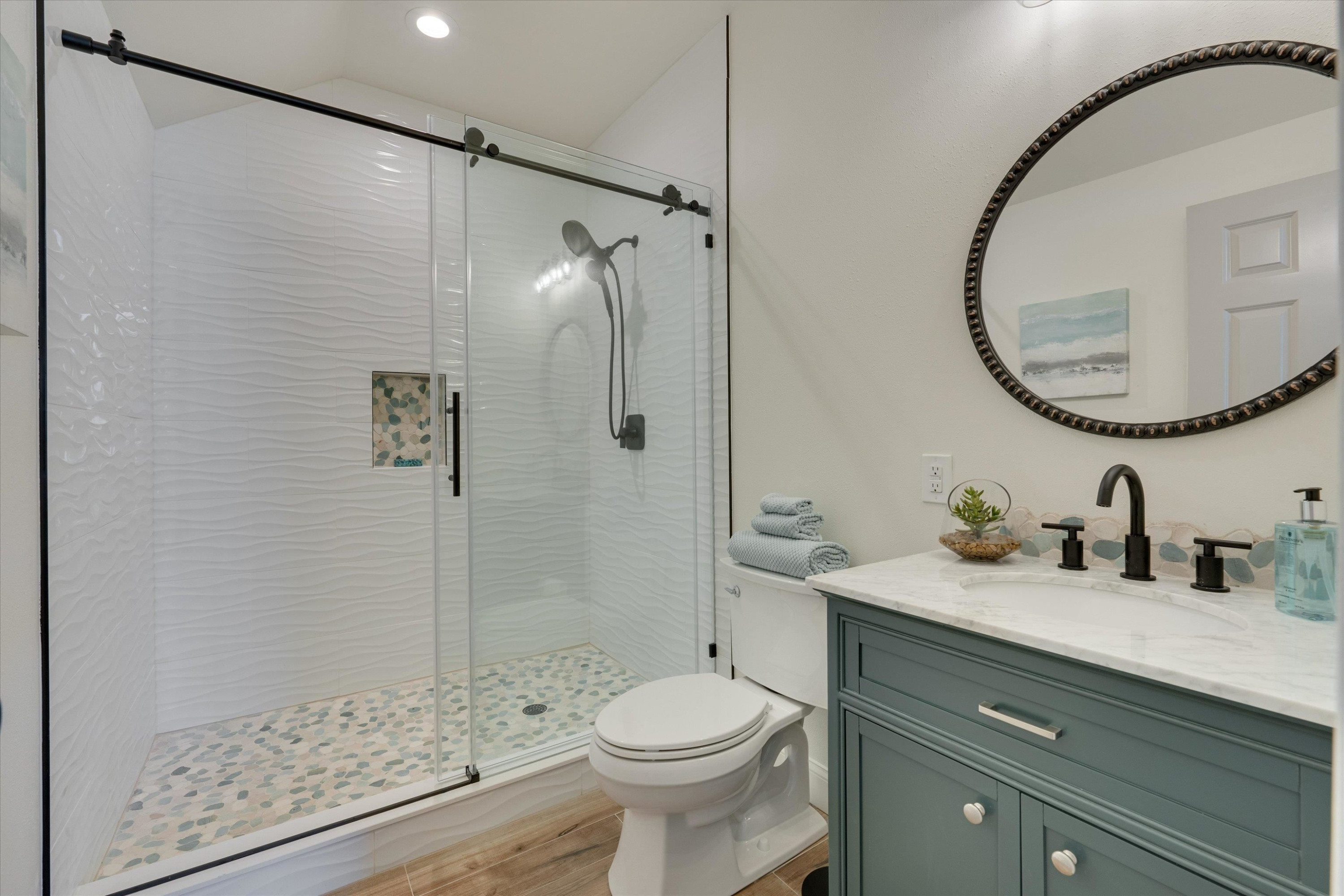 2617 Needle Pine Drive Apex, NC 27539 - Photo 33 of 42 a bathroom with a sink a toilet and a mirror
