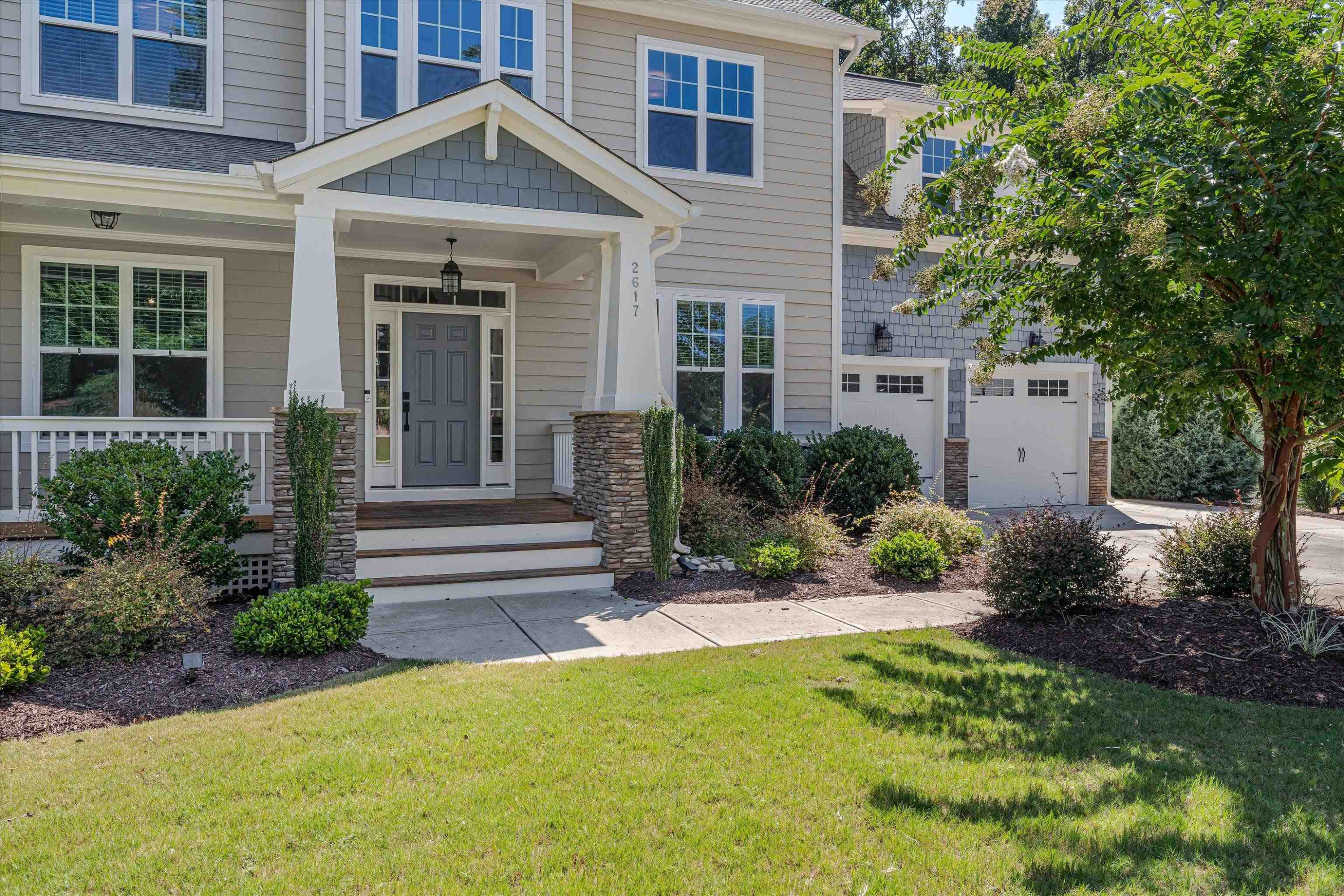 2617 Needle Pine Drive Apex, NC 27539 - Photo 6 of 42 a view of a house with potted plants and a large tree