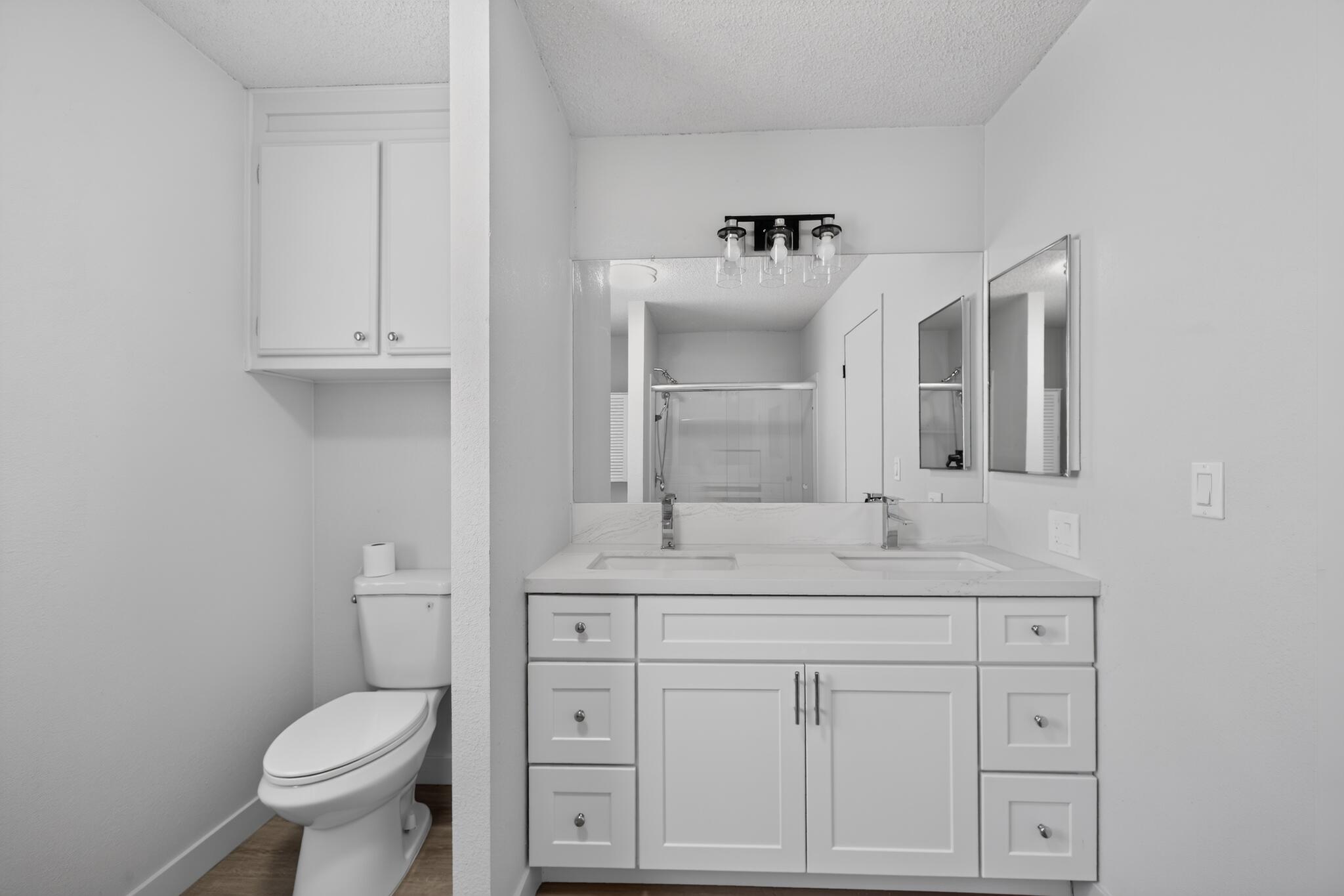 15181 Van Buren Boulevard, Unit 102 Riverside, CA 92504 - Photo 23 of 29 a bathroom with a toilet sink and mirror