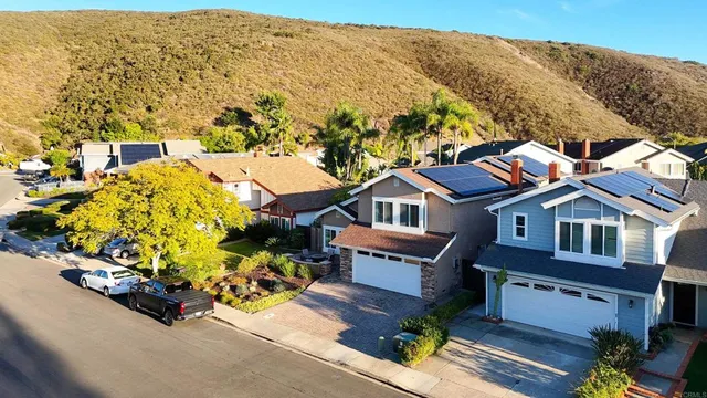 an aerial view of a house with a garden and mountain view