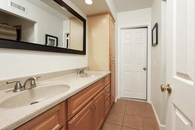 a view of a patio with a table and chairs and potted plants