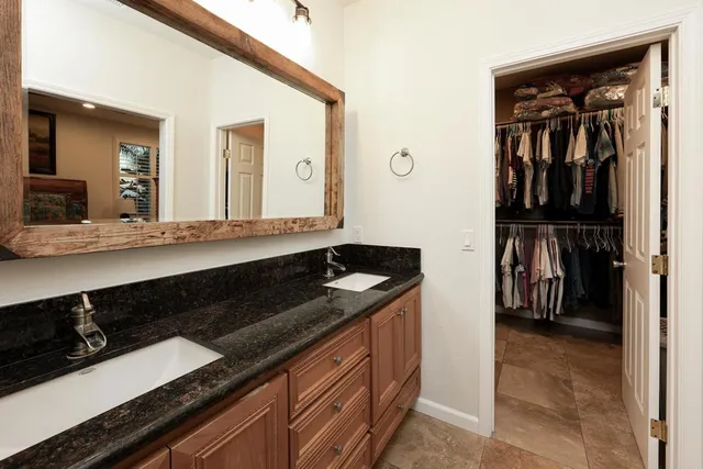 a view of a patio with table and chairs potted plants and a large tree