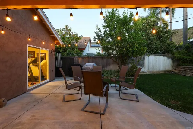 a view of a backyard with large trees