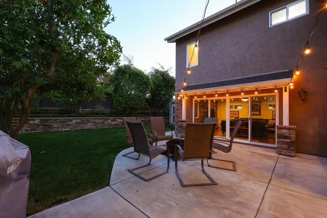 a view of a patio with table and chairs and potted plants