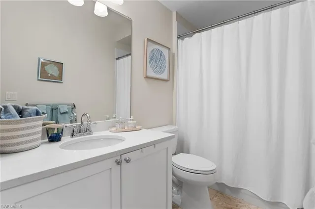 a bathroom with a toilet a sink and a mirror