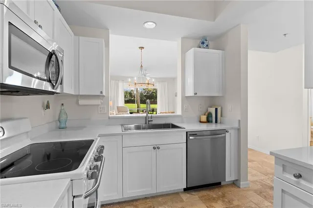 a kitchen with a sink cabinets and a stove