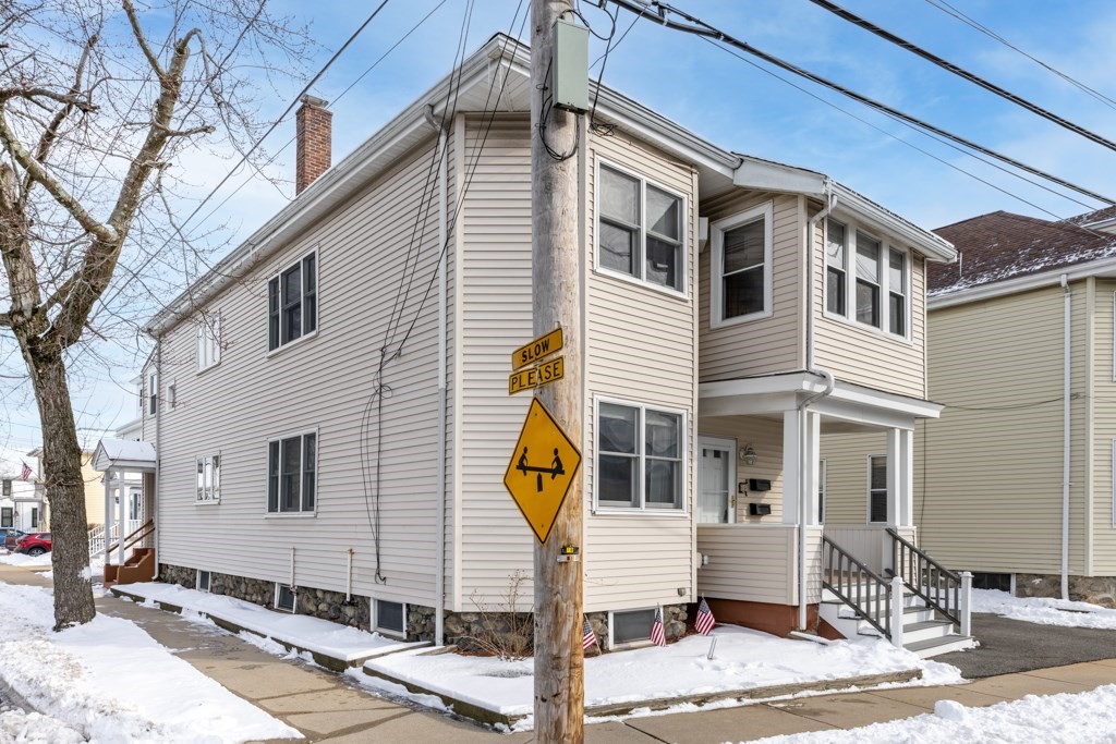 64 Maple Street Belmont, MA 02478 - Photo 21 of 22 a front view of a house with parking space