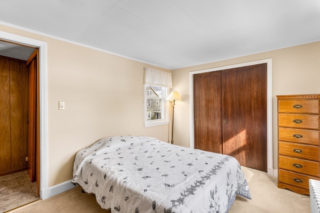 64 Maple Street Belmont, MA 02478 - Photo 8 of 22 a bedroom with a bed and a dresser