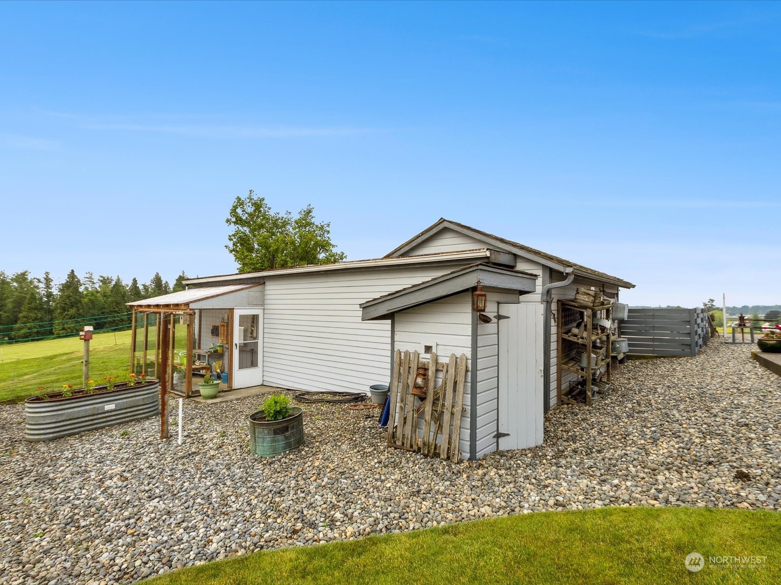 2625 Mountain View Road Ferndale, WA 98248 - Photo 17 of 40 a small white house with a small yard and a large tree