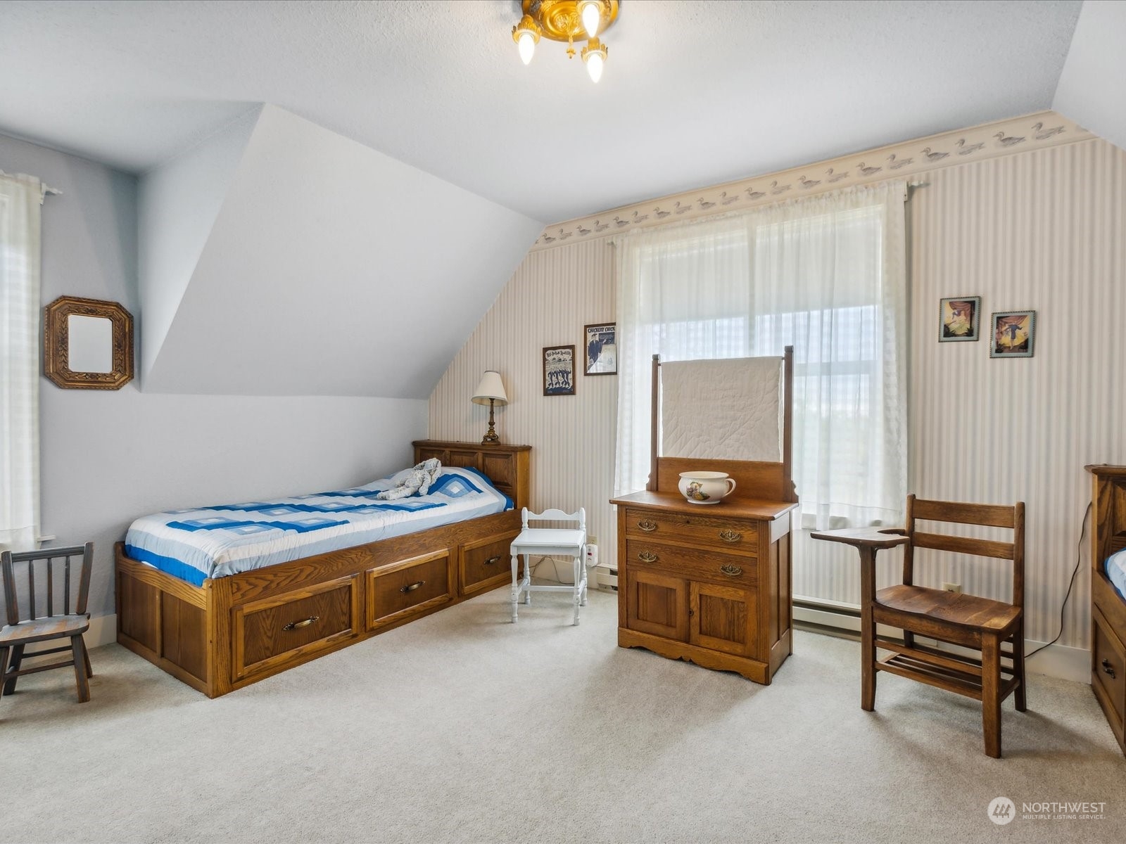 2625 Mountain View Road Ferndale, WA 98248 - Photo 29 of 40 a bedroom with a bed and a chandelier