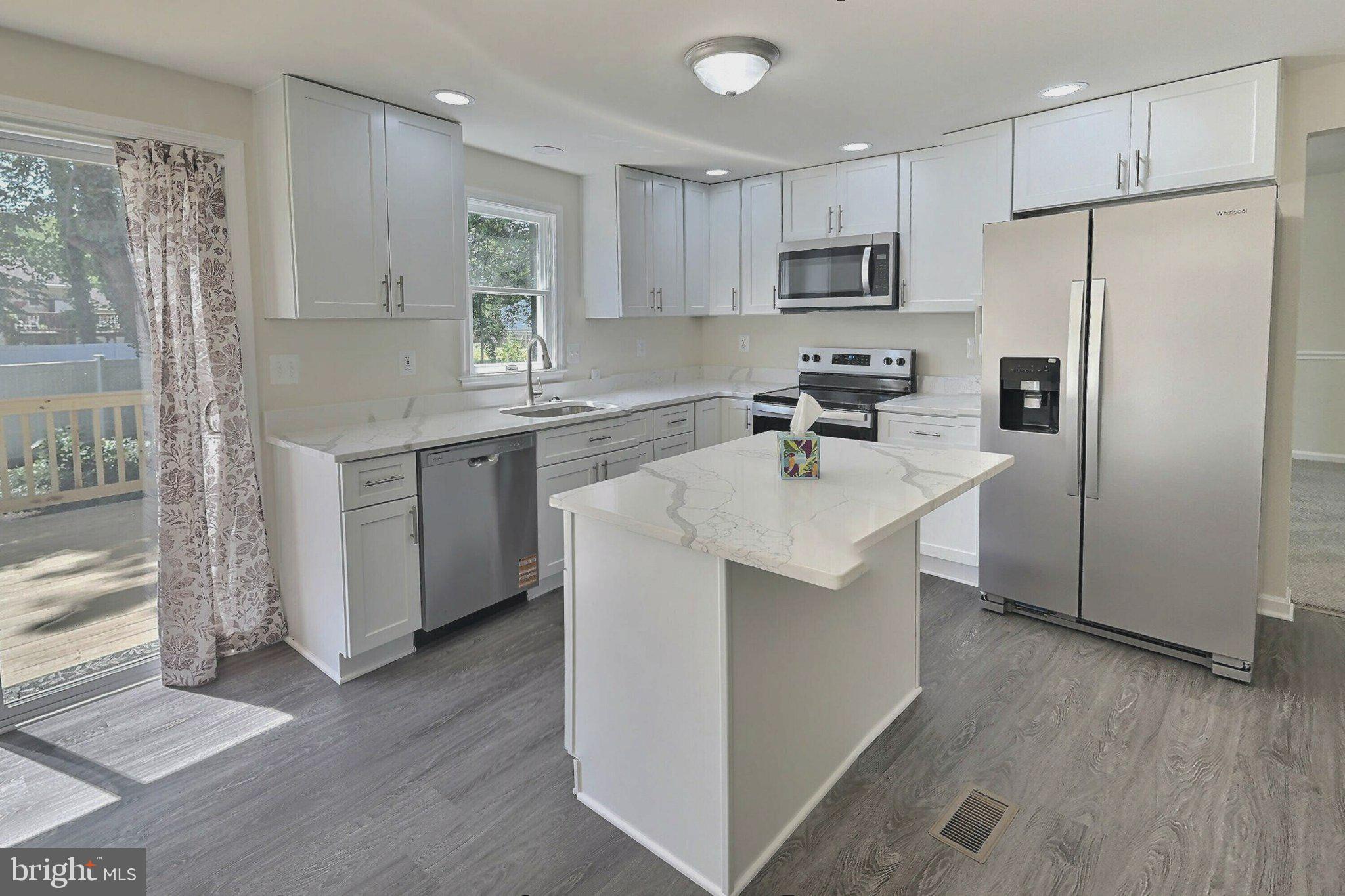 2001 Powder Horn Drive Fort Washington, MD 20744 - Photo 6 of 26 a kitchen with stainless steel appliances a refrigerator stove microwave and sink