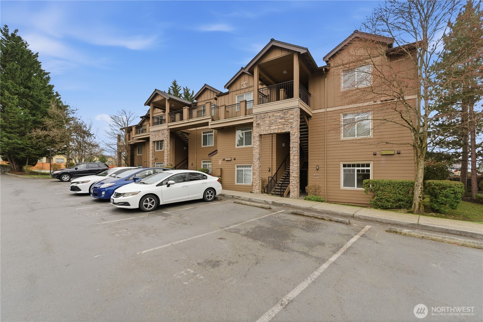 a view of a car parked in front of a brick house