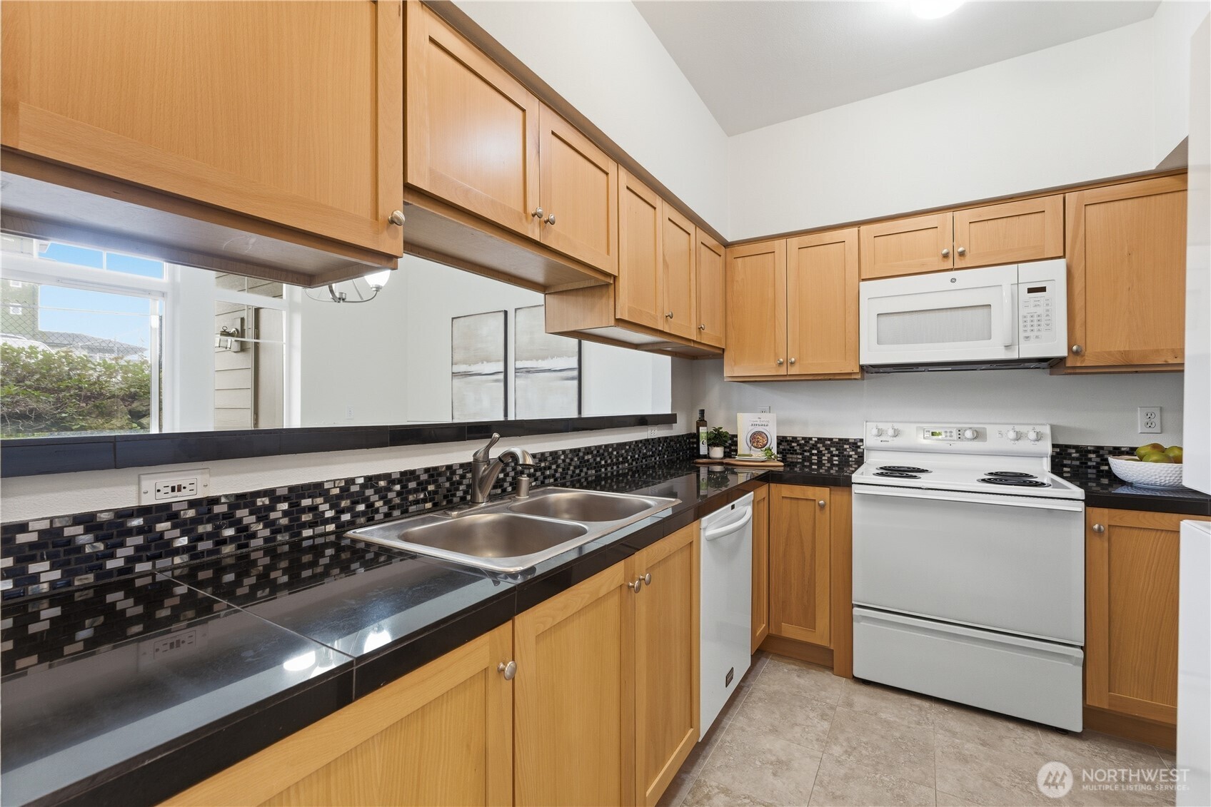 18930 Bothell Everett Highway, Unit G105 Bothell, WA 98012 - Photo 13 of 21 a kitchen with stainless steel appliances granite countertop a sink stove and cabinets