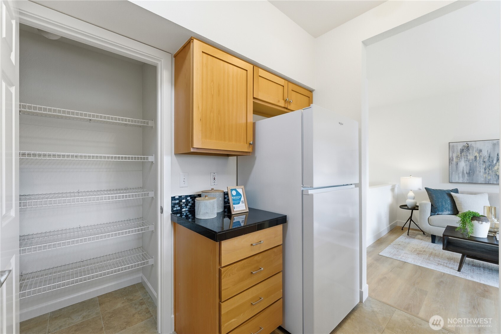 18930 Bothell Everett Highway, Unit G105 Bothell, WA 98012 - Photo 16 of 21 a kitchen with a refrigerator and cabinets