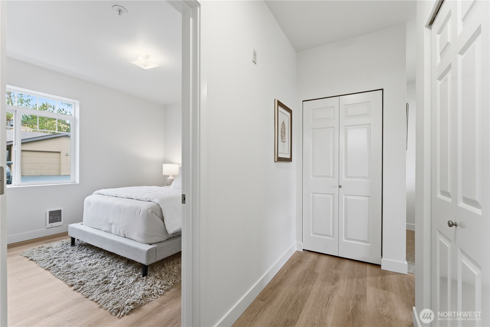 18930 Bothell Everett Highway, Unit G105 Bothell, WA 98012 - Photo 17 of 21 a bedroom with a bed and wooden floor