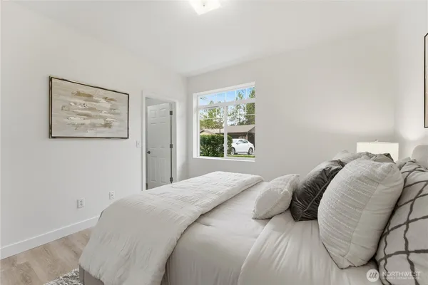 a bedroom with a bed and a window