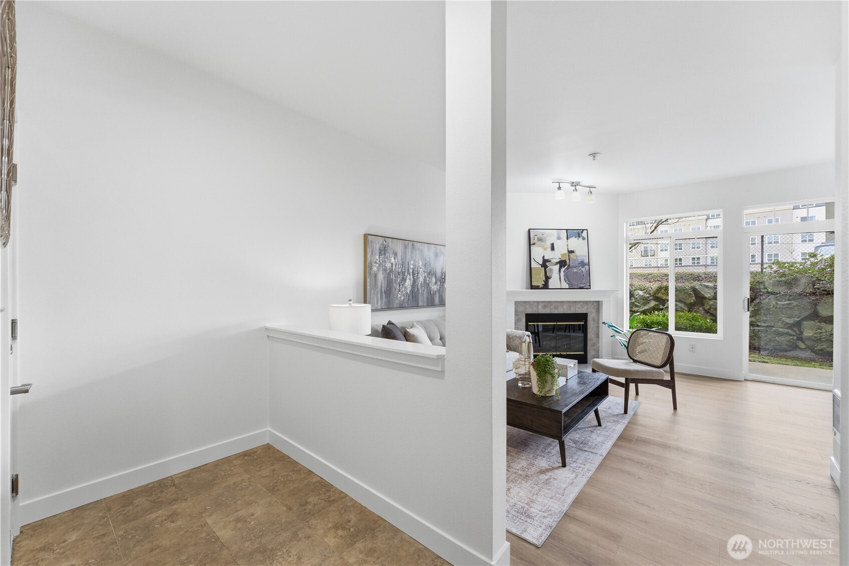 18930 Bothell Everett Highway, Unit G105 Bothell, WA 98012 - Photo 5 of 21 a living room with furniture and a fireplace