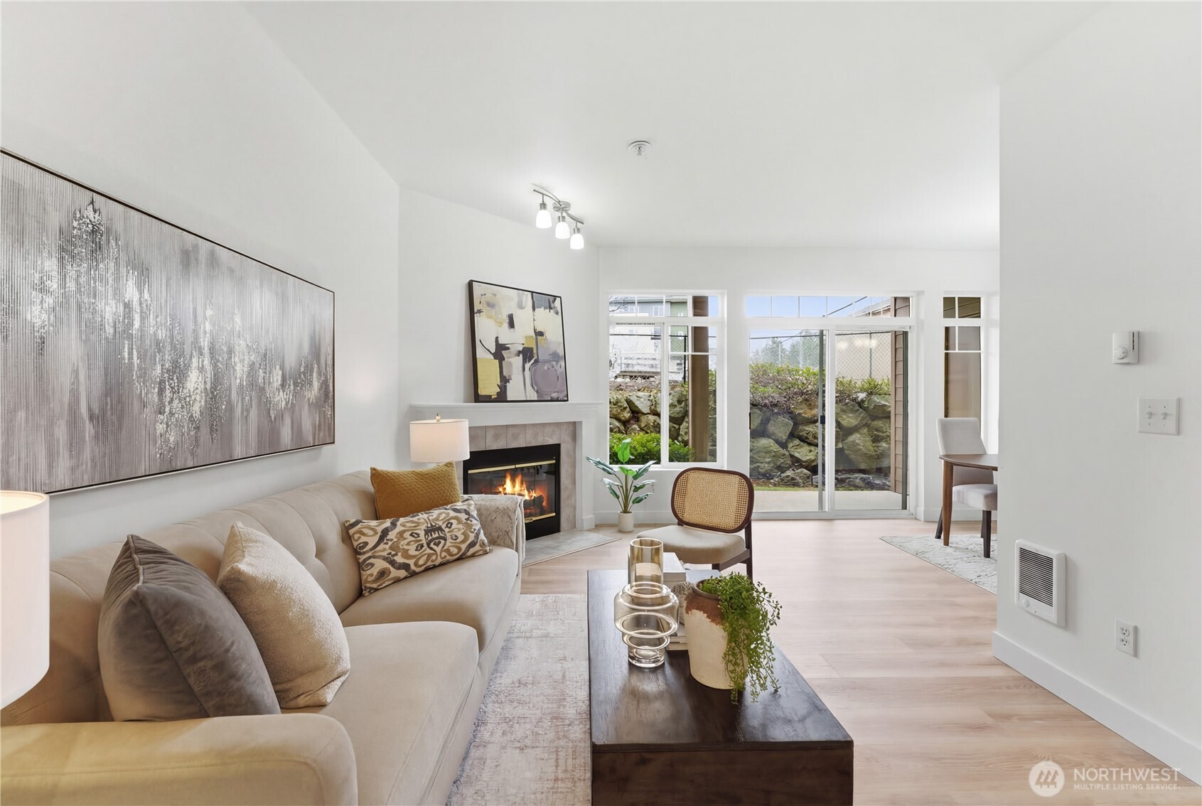 18930 Bothell Everett Highway, Unit G105 Bothell, WA 98012 - Photo 6 of 21 a living room with furniture fireplace and a large window