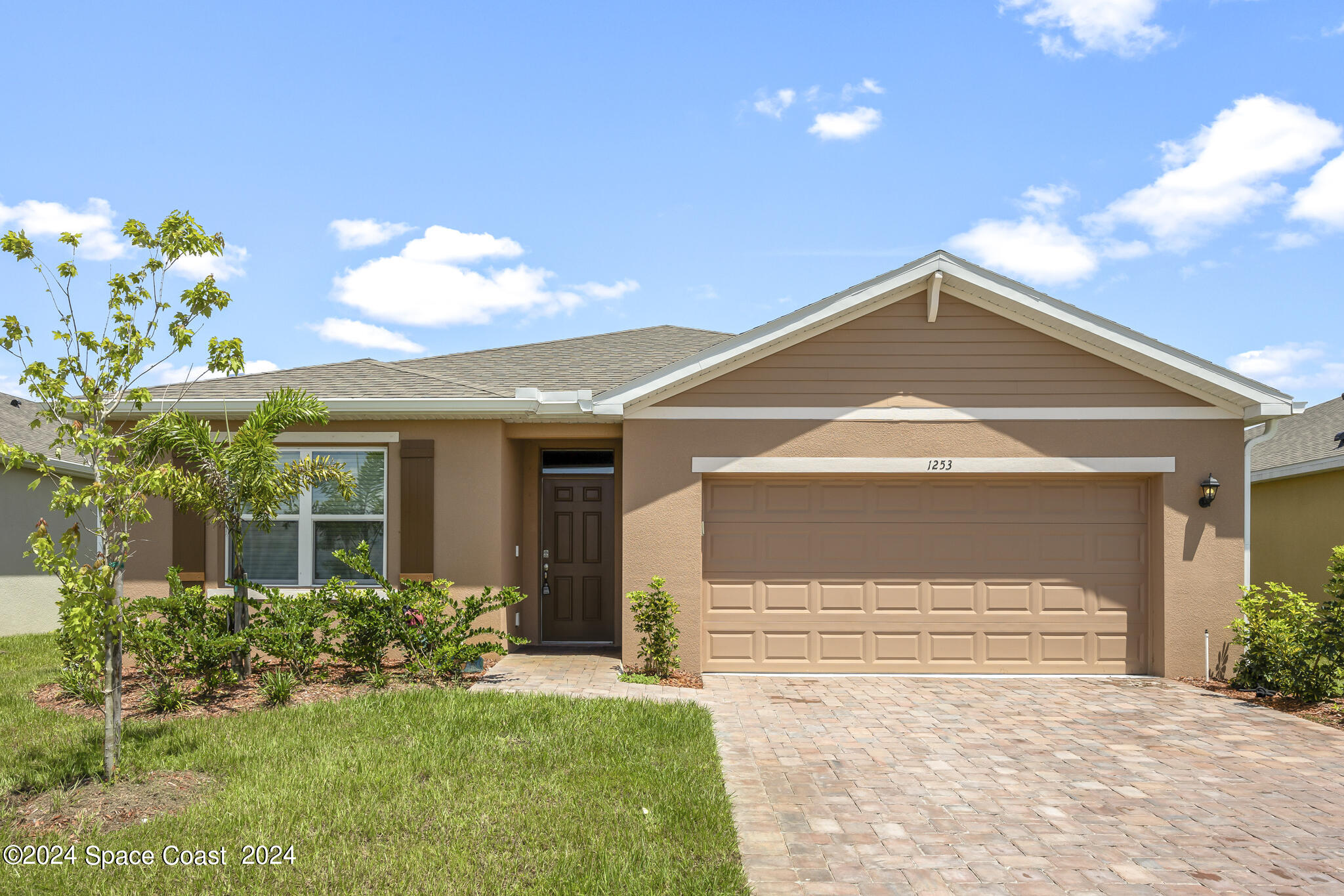 a front view of a house with a yard