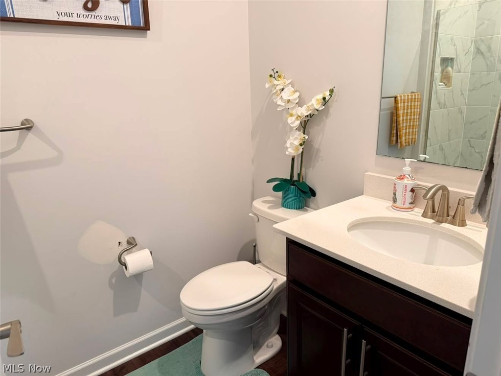 863 River Run Road Aurora, OH 44202 - Photo 16 of 47 Bathroom featuring a dark wood-finish vanity with a light-toned countertop, an undermount sink with a brushed nickel faucet, and a large wall mirror