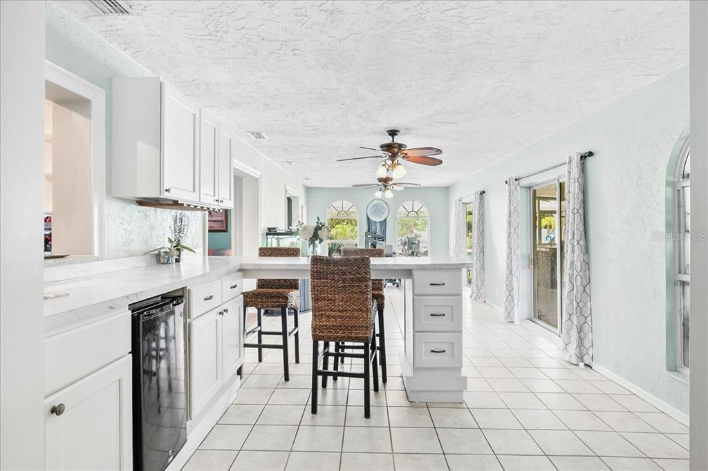 1302 Georgetowne Circle Sarasota, FL 34232 - Photo 12 of 28 a kitchen with white cabinets and appliances