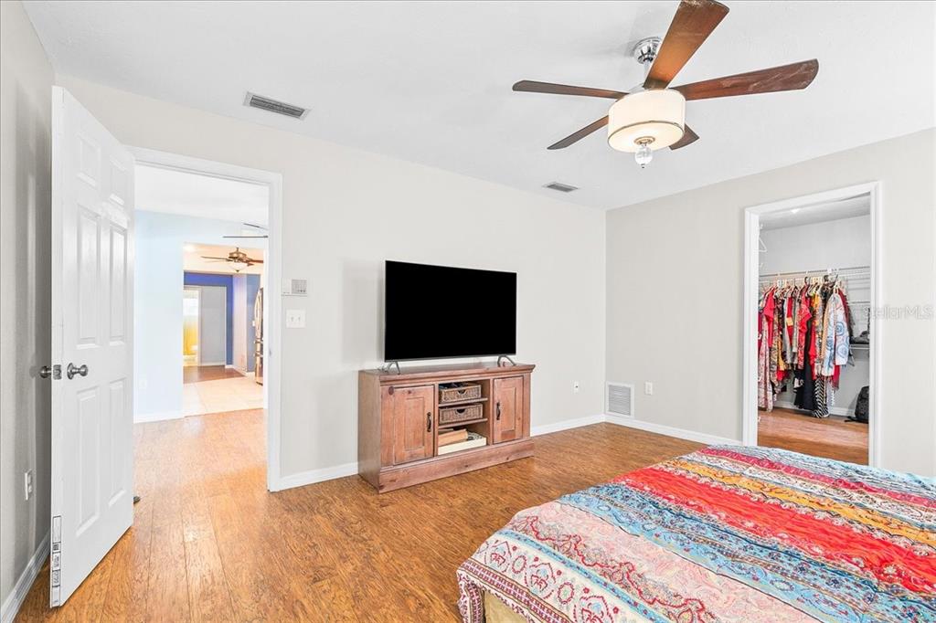 1302 Georgetowne Circle Sarasota, FL 34232 - Photo 15 of 28 a bedroom with a bed and a flat screen tv