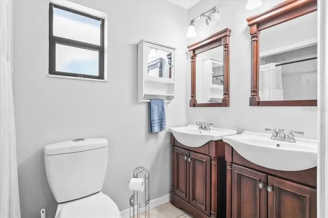 a bathroom with a toilet a sink and a window