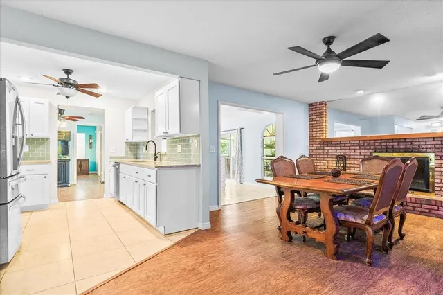 a dining room with stainless steel appliances kitchen island granite countertop furniture and a kitchen view