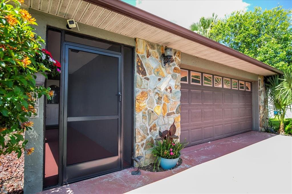 1302 Georgetowne Circle Sarasota, FL 34232 - Photo 2 of 28 a front view of a house with a garden